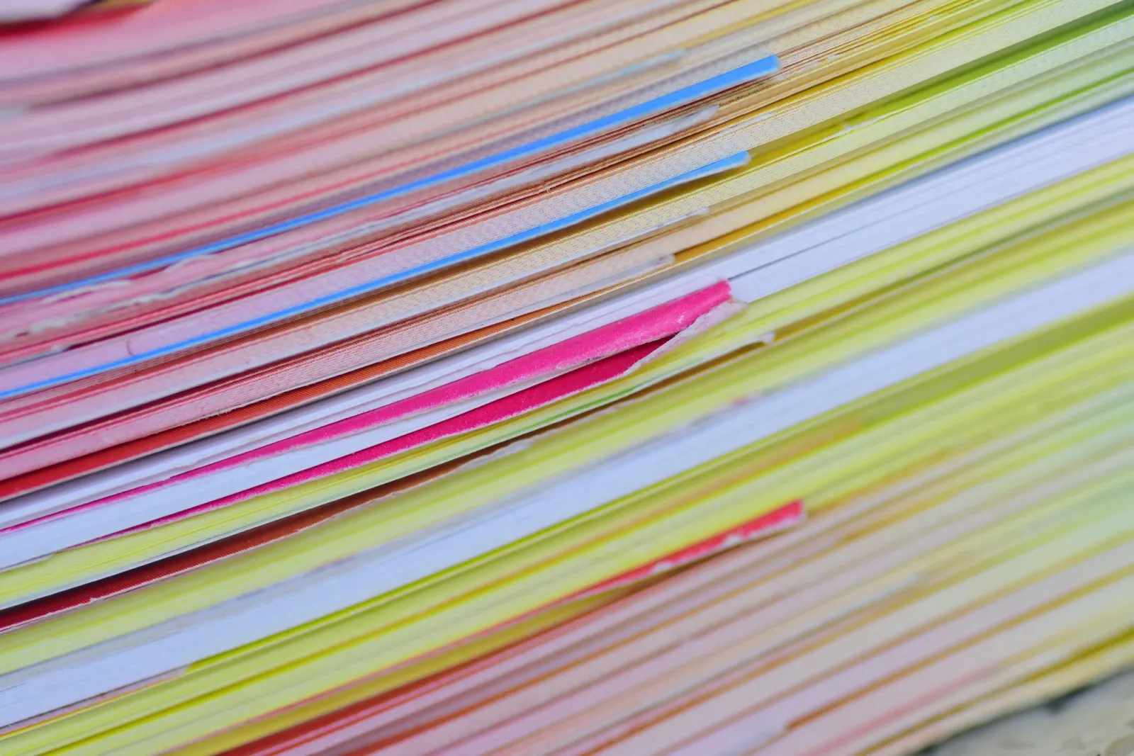 Side view of a stack of colourful paper layers
