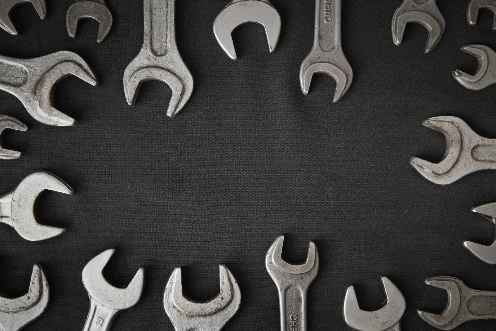 Spanners arranged in a circle on a dark background