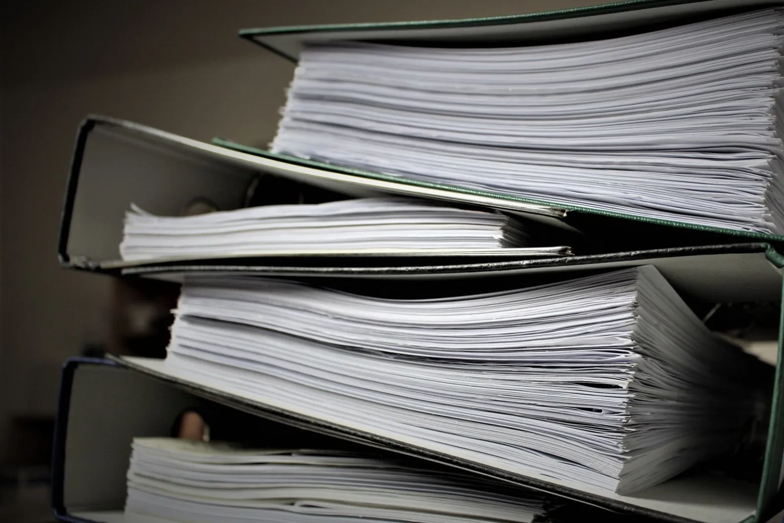 Stacked folders with thick piles of paper